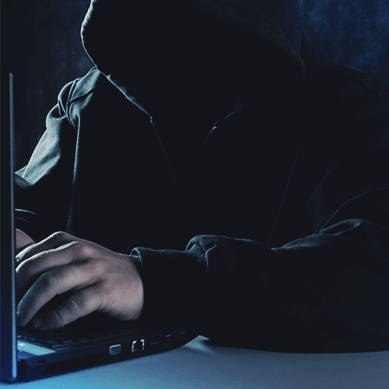 Cybercriminal in front of a laptop