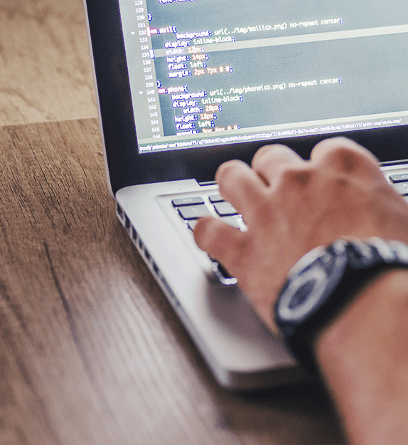 Person coding on laptop