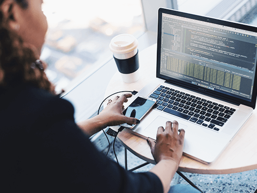 Person working on a laptop with code on the screen