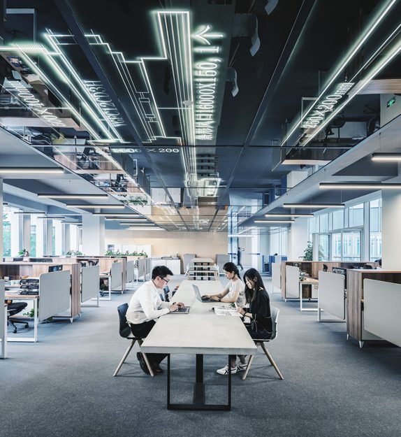 People work in an open plan office
