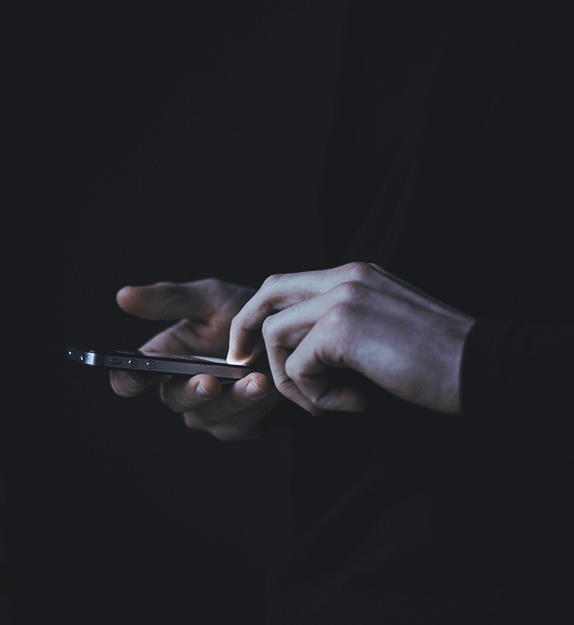 Hands holding a cell phone and typing on it