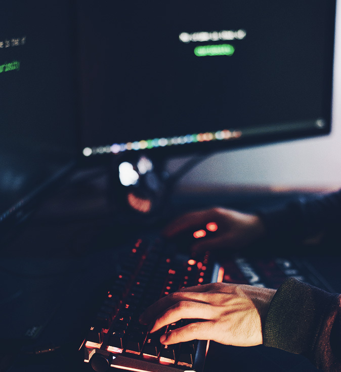 Person working on laptop and typing on keyboard
