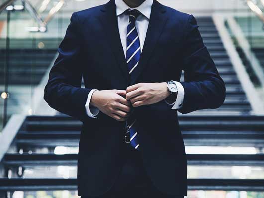 Person in suit standing on stairs