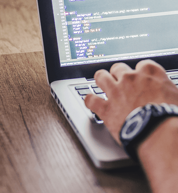 Person coding on laptop