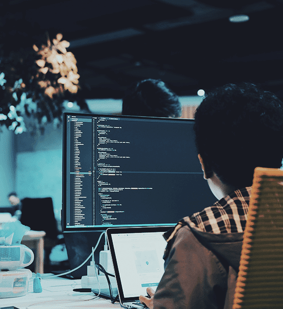 Person working on a laptop with code on the screen