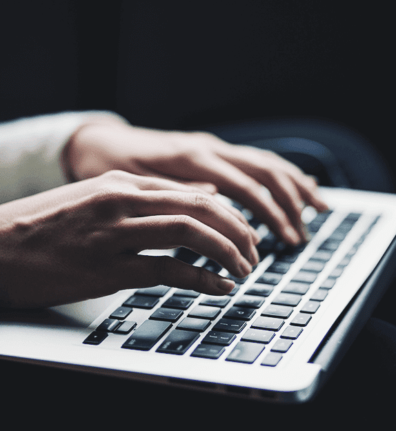 Person typing on a keyboard from a laptop