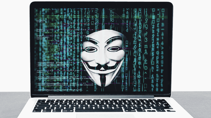 Laptop with code and haker on the screen