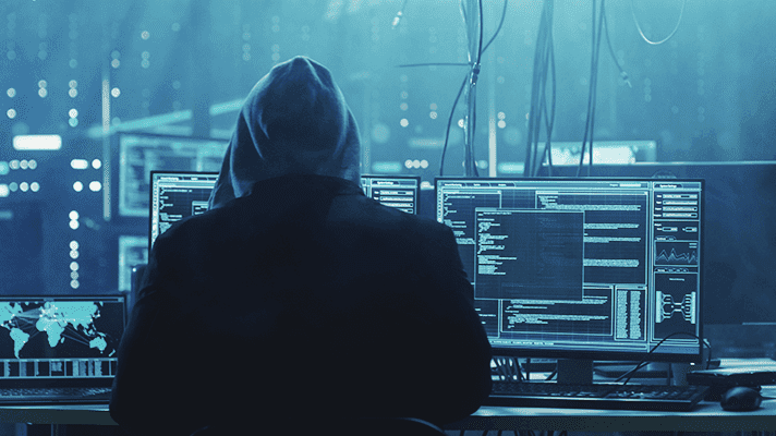 Cybercriminal sits in front of a computer with an open terminal window